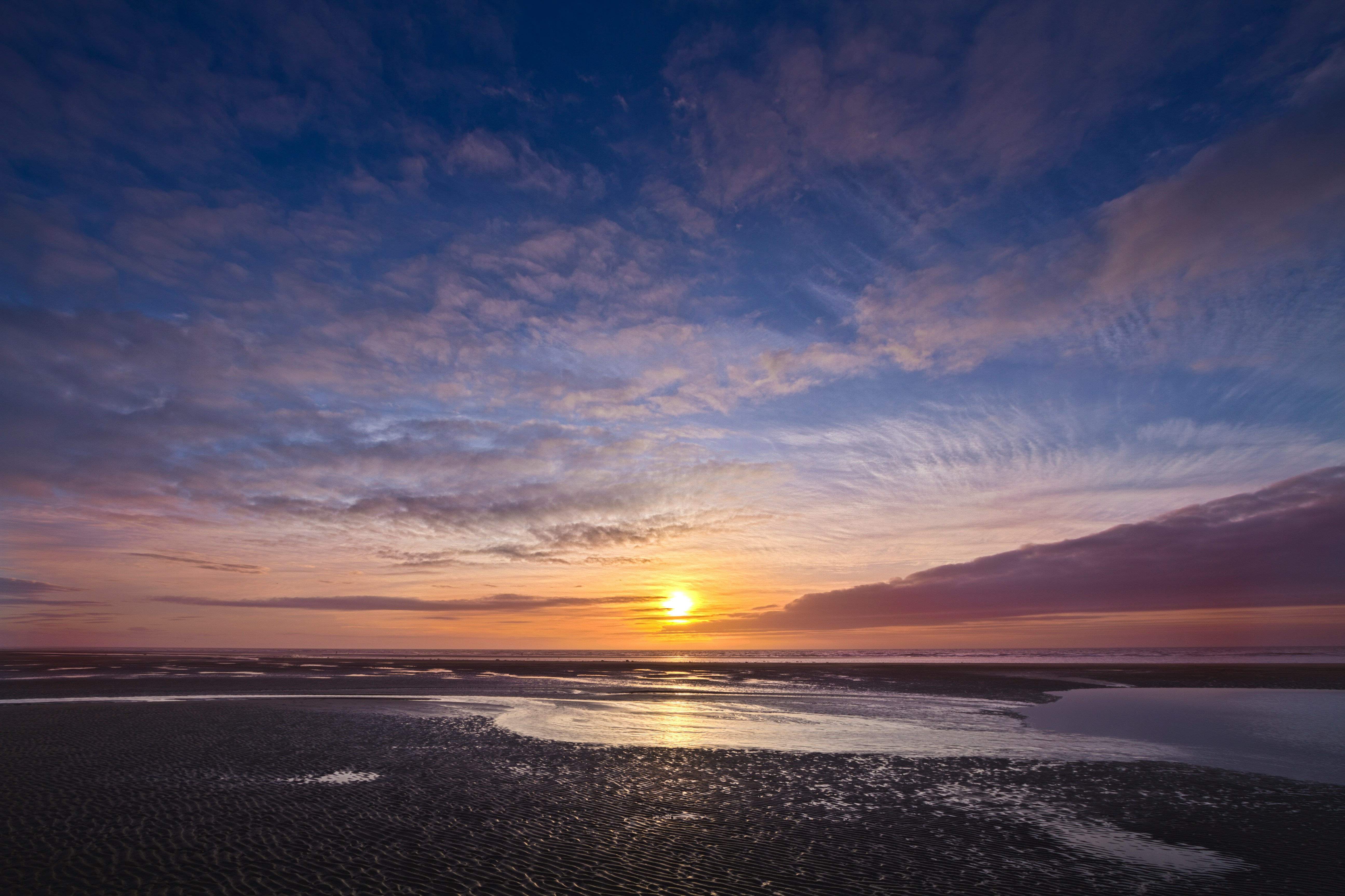 body of water under blue sky during sunset